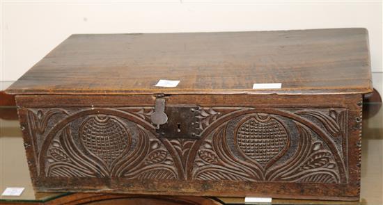 A late 17th/early 18th century oak bible box, with hinged top and fruit and foliate carving, W.71cm